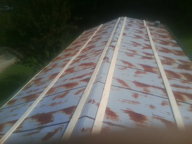 Rusted metal roof panels with new wood purlins before replacement — Storm Damage Roof Repair in Mount Clemens by Roofing Brothers